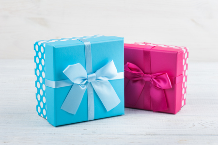 A red and blue present boxes on white wooden backgroundの写真素材
