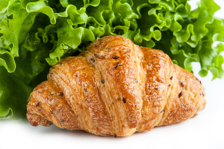 Croissant and green salad closeupの写真素材
