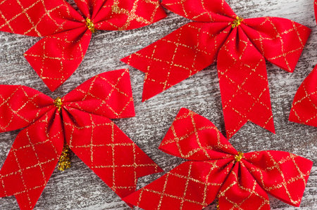 Red bows on a wooden background. Top view
