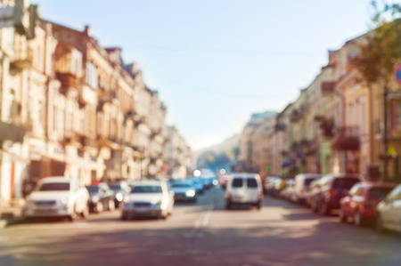 Blurred old city downtown background. Out of focus cars at street. Toned photo.のeditorial素材