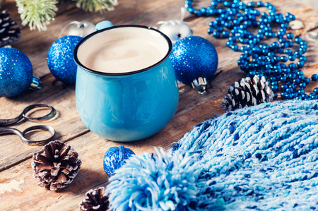 Blue mug of coffee, Christmas decor. Closeup on dark wooden backgroundの写真素材