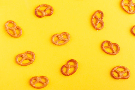 Traditional German pretzels on yellow background