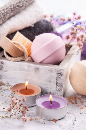 Pink aroma bath bombs in SPA arrengement with dry flowers and lit candle の写真素材