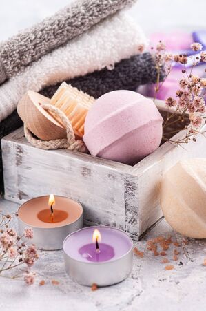 Pink vanilla aroma bath bombs in SPA arrengement with dry flowers and lit candle の写真素材