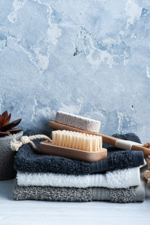 Spa composition with body brushes and towels. Aromatherapy arrangement, zen still life on concrete...