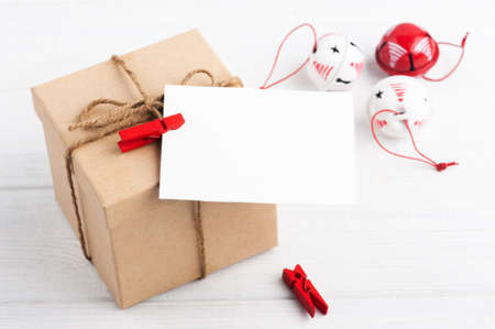 Blank empty note and white Christmas toys on wooden rustic background. Winter set with copy spaceの写真素材