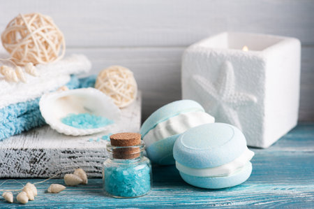 Spa composition with bath bomb macaroon and dry flowers on rustic background. Candles and salt. Beauty treatment and relaxの写真素材