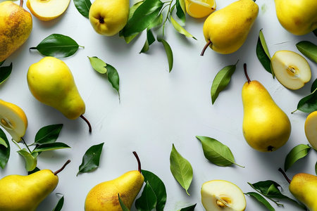 Frame of ripe yellow pears with leaves and fruit halves, top viewの素材