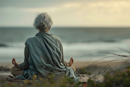 Senior woman meditating on the beach, calm and relaxationの素材