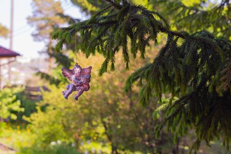 Angel figurine hanging on a fir branch. New Year's compositionの写真素材