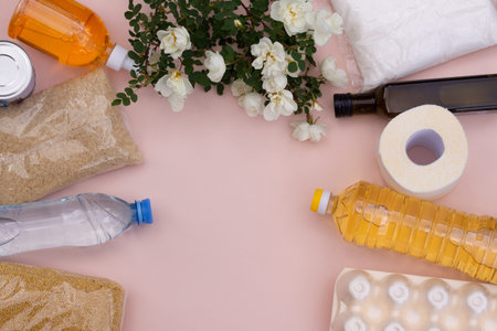 Products and flowers lie on a pink background. Delivery of products for donations. Help with the...