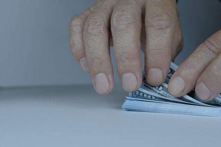 Money concept. Pack of dollars and fingers. A man counts money.