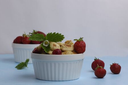 Small grain pancakes with strawberries, fast healthy Breakfast, pancake porridge on a blue backgroundの写真素材