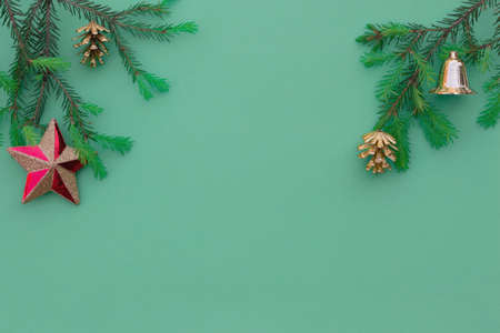 Christmas festive composition. Fir young branches on a green background. Flat lay, top view, copy space. New year greeting cardの写真素材