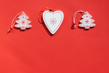 wooden Christmas toys on a red background. Flat lay, copy space. Christmas card