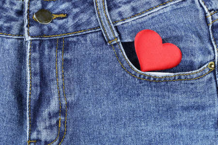 silk red heart in jeans pocket. View from above.の写真素材