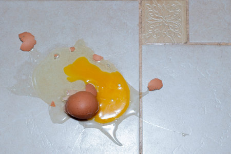 broken raw egg on the floor. view from above. copy space.