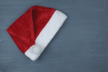 Red Santa Claus hat on a gray background. New Year costumeの写真素材