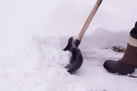 Snow removal in the garden in winter after a snowfall.の写真素材