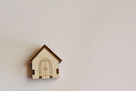 Small model of a wooden house on a white background. The concept of building a house. The project of a country house.の写真素材