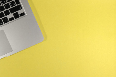 laptop keyboard on a yellow background. Copy space. View from aboveの写真素材