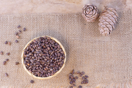 Wicker basket with pine nuts and cones. Healthy eating conceptの写真素材
