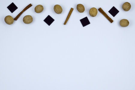 cinnamon, nuts and pieces of chocolate on a light background. copy spaceの写真素材
