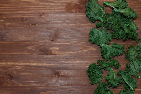 Kale cabbage leaves on a wooden rustic table. Healthy food concept. Copy space.の写真素材