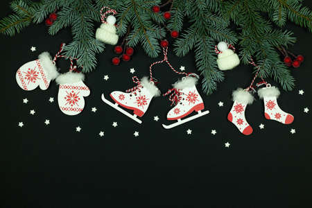 Merry Christmas and Happy New Year holidays background. Christmas tree on a black background. Composition from wooden Christmas tree decorations and snowflakesの写真素材