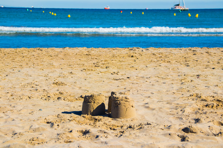 Pyramids of sand on the background of the sea.の写真素材