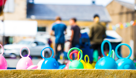 Plastic ducks with rings in the back float in the water on a local fair.の写真素材