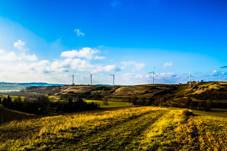 Landscape with a working wind turbines in field . Concept of ecological lifestyle.