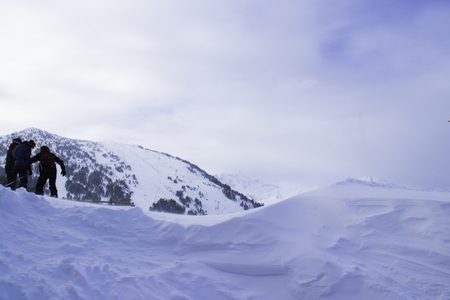 A group of skiers at a ski station covered with snow make a break between the descentsの写真素材