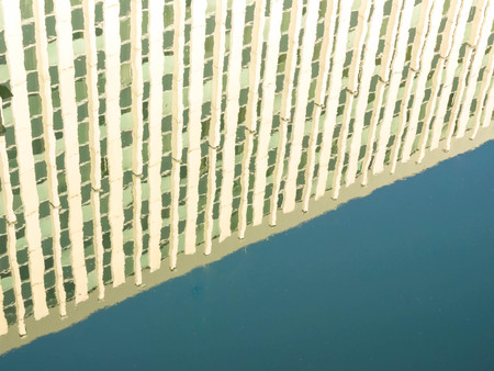 Reflection of an office building in the water.の写真素材