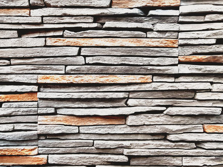 Stone wall texture, slim briks.Closeup surface brick pattern at old stone brick wall textured...