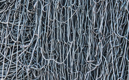 Black fishing net closeup, old and used, on the quayの写真素材
