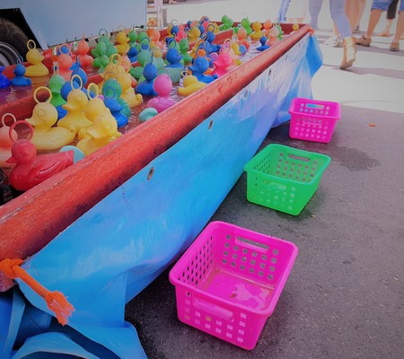 Playing plastic colorful ducklings on a fairground partyの写真素材
