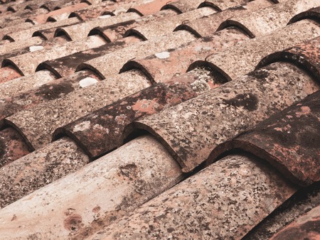Roof with pattern of old red tiles closeupの写真素材