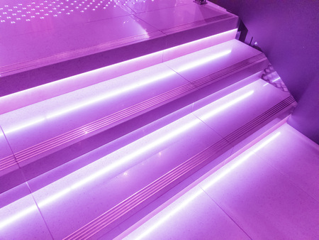 Stairs in the building in modern neon magenta lighting.の写真素材