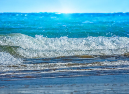 Sea waves sweeping ashore with white foam