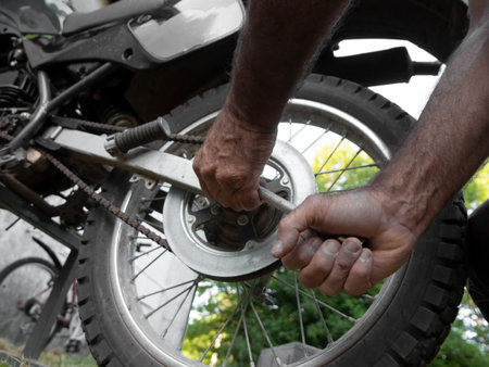 Adjustments on motorbike. Repairs a motorcycle engine. Maintenance