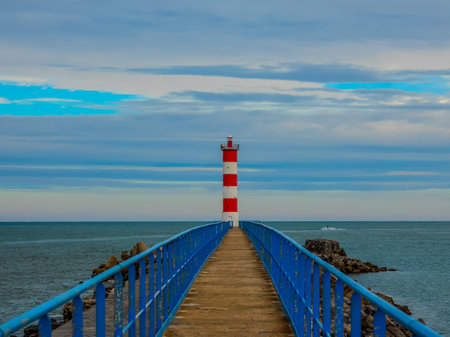 Pass to the lighthouse on the stone walkway between the safety ramps.