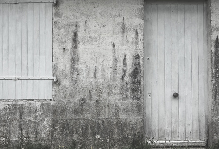 Window and door of a old village house with wooden flaky texture white color. Retro style.の写真素材