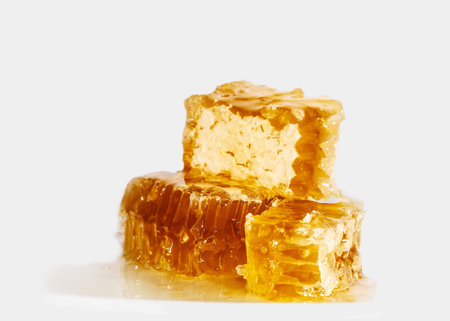 Sweet honeycomb with honey on white background, bee products, organic concept