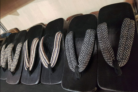 Japanese slippers with wooden soles laid out on the counter for sale