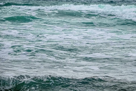 Background from the water of the undulating sea with splash.