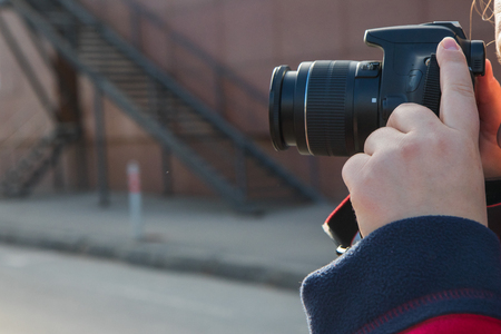 photographer hands with camera in the street photo shooting process.の写真素材