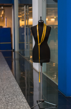 female mannequin with measuring tape on shop backgroundの写真素材