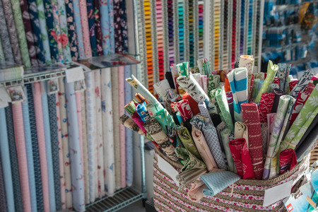Traditional fabric store with stacks of colorful textiles, fabric rolls at market stall - textile industry background with blurred. Fabric Store, Traditionalの写真素材