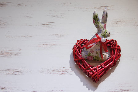 easter bunny and red heart on the white wooden background